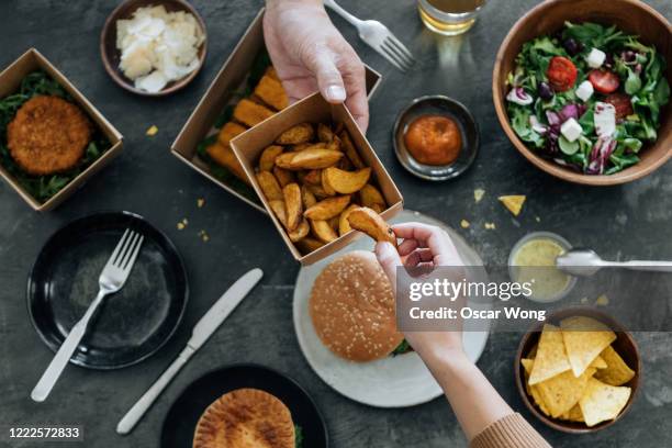 sharing takeaway fast-food meal - french fries overhead stock pictures, royalty-free photos & images