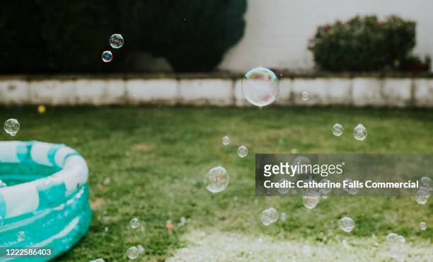 paddling pool and bubbles - inflate stockfoto's en -beelden
