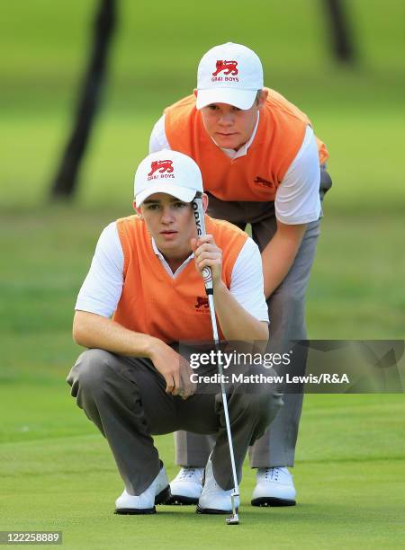 Harrison Greenberry and Natham Kimsey of Great Britain and Ireland line up a putt during their Foursome match against Maximilian Rottluff and Robin...