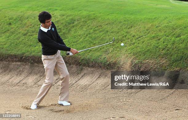 Javier Sainz of the Continent of Europe plays out of the bunker during their Foursome match against David Boote of Great Britain and Ireland during...