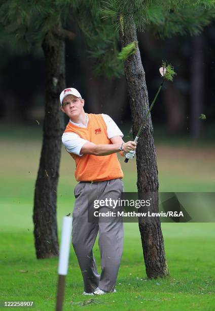 Natham Kimsey of Great Britain and Ireland plays a shot from the rough during their Foursome match against Maximilian Rottluff and Robin Goger of the...