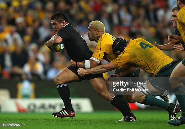 Keven Mealamu of the All Blacks is tackled by Digby Ioane and Dan Vickerman of the Wallabues during the Tri-Nations Bledisloe Cup match between the...