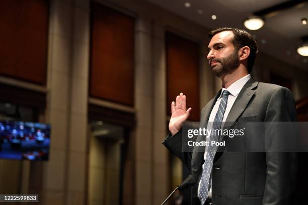 John Elias, a career official in the Justice Department's antitrust division, is sworn in before the House Judiciary Committee for a hearing on...