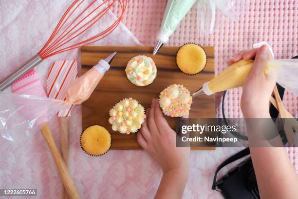 top view pastel coloured cupcake decoration with baking equipment and camera - decorating a cake stock pictures, royalty-free photos & images