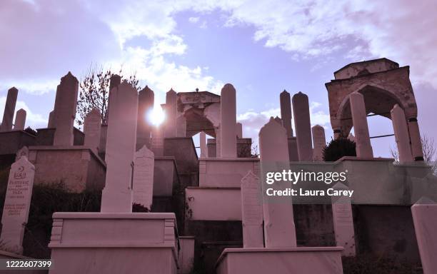 White gravestones overlook the town of Sarajevo at sunset, marking victims of the Yugoslav War on December 03, 2011 in Sarajevo, Bosnia.