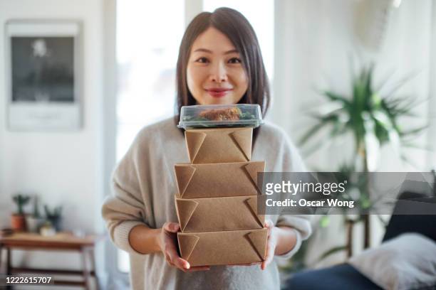 young woman carrying takeaway food boxes - take out food bildbanksfoton och bilder