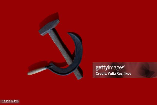 sickle and hammer on the red background - sozialismus stock-fotos und bilder