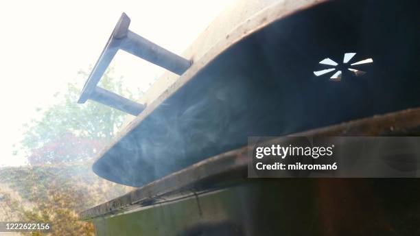 bbq with smoke - bbq smoker stock pictures, royalty-free photos & images