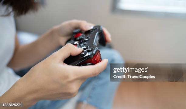 computer game competition. gaming concept. excited girl playing video game with joystick. young people having fun with new technology console online. - handheld video game stock pictures, royalty-free photos & images