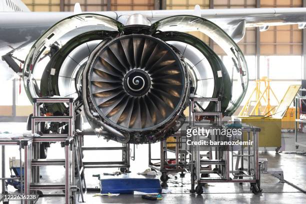 aircraft jet engine maintenance in airplane hangar - manufacturing stock pictures, royalty-free photos & images