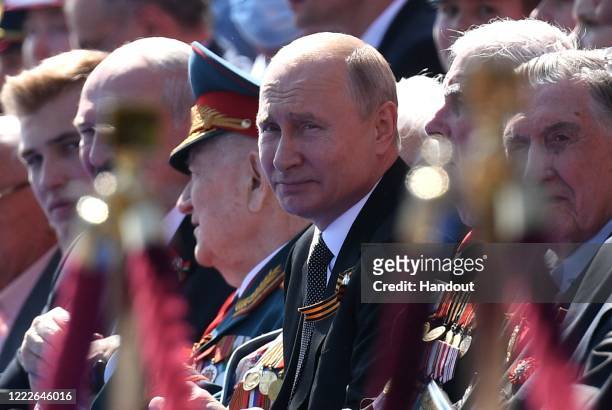 President of Russia and Commander-in-Chief of the Armed Forces Vladimir Putin watches a Victory Day military parade on Red Square, marking the 75th...