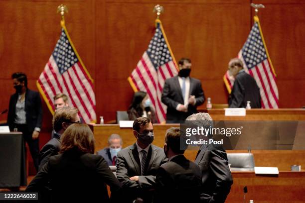 John W. Elias, a prosecutor in the U.S. Justice Department's antitrust division, talks with members of his staff at a hearing of the House Judiciary...