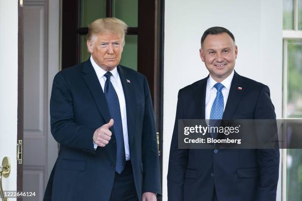 President Donald Trump, left, gives a thumbs up with standing with and Andrzej Duda, Poland's president, at the West Wing of the White House in...