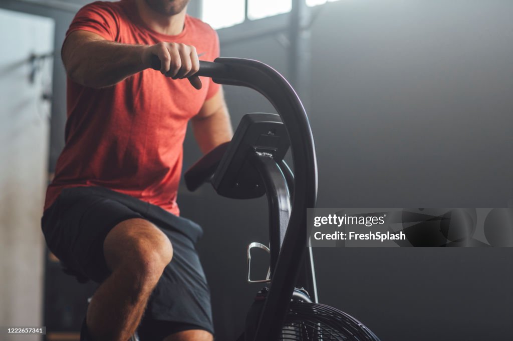 Unrecognizable Man Doing Exercise on a Gym Stationary Bike, gym Concept