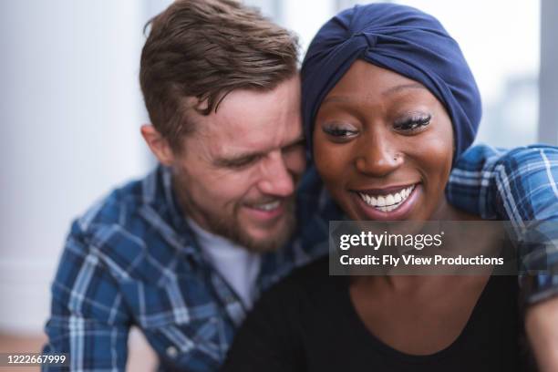 husband hugging recovering wife - chemotherapy man stock pictures, royalty-free photos & images