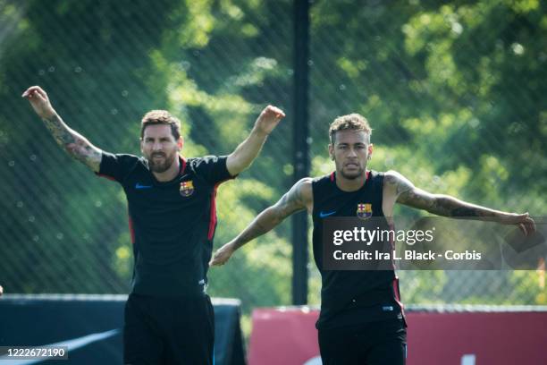 Lionel Messi of Barcelona and Neymar of Barcelona with their arms up as they warm up next to each other during the International Champions Cup...