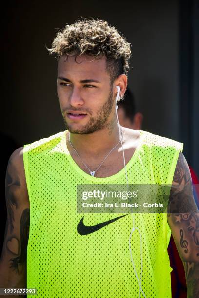 Neymar of Barcelona after the International Champions Cup Barcelona training session wearing a yellow bib and the Nike Logo and with earbuds in his...