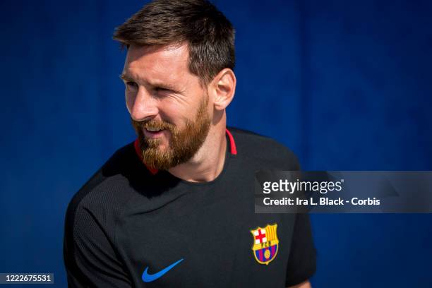 Lionel Messi of Barcelona walks onto the pitch for the International Champions Cup Barcelona training session with a solid blue background. On April...