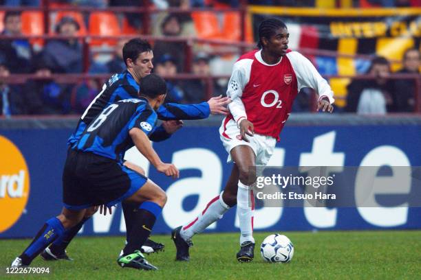 Nwankwo Kanu of Arsenal takes on Sabri Lamouchi and Jeremie Brechet of Inter Milan the UEFA Champions League Group B match between Inter Milan and...