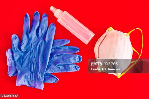 protective mask, medical gloves and hand sanitizer - red glove stock pictures, royalty-free photos & images