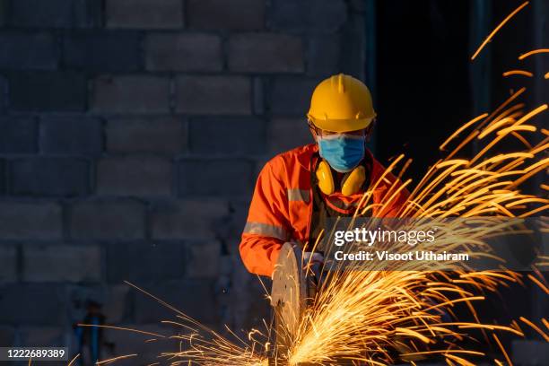 technical wear protective face masks for safety coronavirus disease 2019 (covid-19) are cutting iron - respiratory protection construction stock pictures, royalty-free photos & images