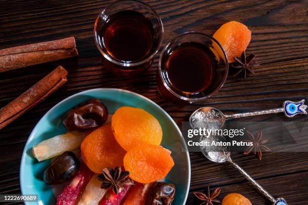 arabic tea in traditional glasses and sweets on a desert background. - qatar food stock pictures, royalty-free photos & images
