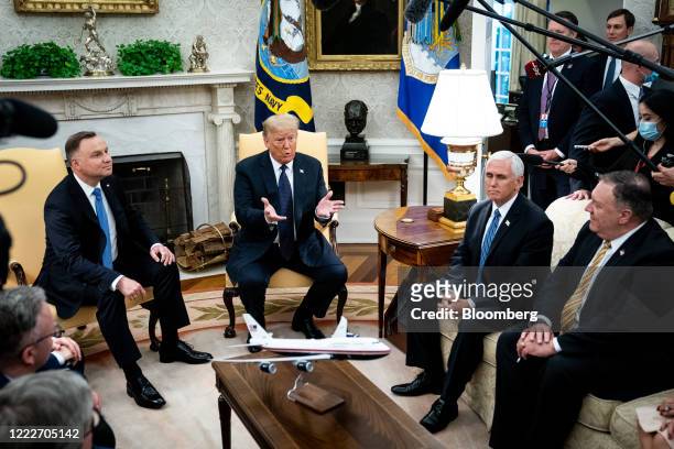President Donald Trump, center, speaks as Andrzej Duda, Poland's president, left, listens during a meeting in the Oval Office of the White House in...
