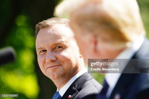 Andrzej Duda, Poland's president, listens as U.S. President Donald Trump, right, speaks during a news conference in the Rose Garden of the White...