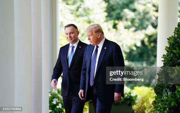 President Donald Trump, right, and Andrzej Duda, Poland's president, arrive to a news conference in the Rose Garden of the White House in Washington,...