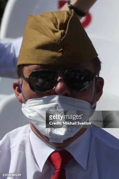 Gazprom's CEO Alexei Miller wears protective mask during the military parade marking the 75th anniversary of Nazi defeat on June 24, 2020 in Moscow,...