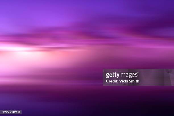 purple motion blur pattern of the sky and beach at sunrise - lilac stockfoto's en -beelden