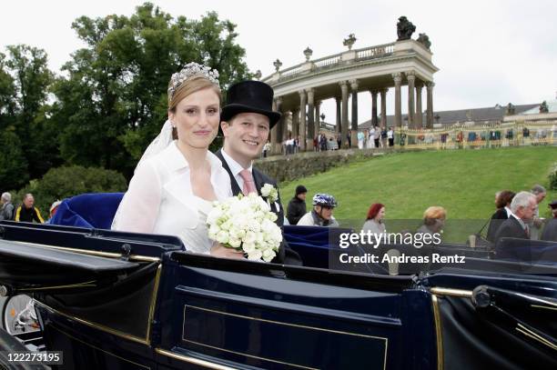 Georg Friedrich Ferdinand Prince of Prussia and Princess Sophie of Prussia smile during their ride in a historical carriage after the religious...