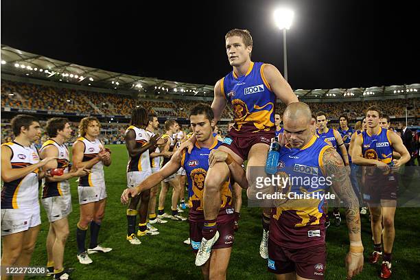 Luke Power is chaired off after announcing his retirement during the round 23 AFL match between the Brisbane Lions and the West Coast Eagles at The...