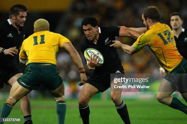 Mils Muliaina of the All Blacks is tackled by Digby Ioane and Pat McCabe during the Tri-Nations Bledisloe Cup match between the Australian Wallabies...