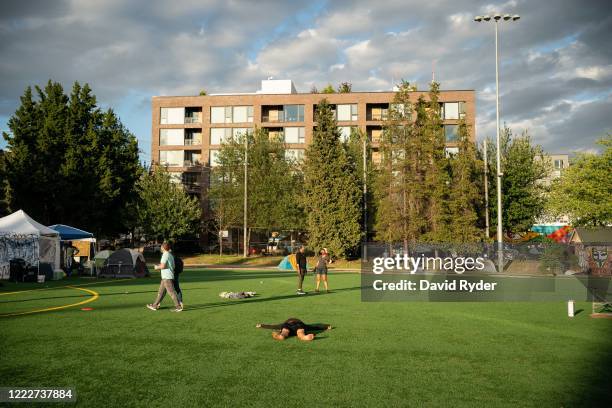 Person lays down in Cal Anderson Park in the area known as the Capitol Hill Organized Protest on June 24, 2020 in Seattle, Washington. On Monday,...