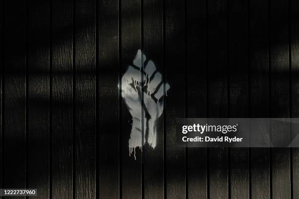 Graffiti in the shape of a fist is seen on a wall in the area known as the Capitol Hill Organized Protest on June 24, 2020 in Seattle, Washington. On...