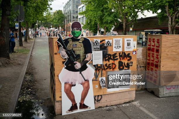 Cutout image of a man holding a firearm, called ANTI-FAiry and created by activists to critique the recent manipulation and misleading use of the...