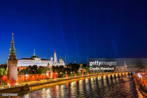 View of the Moscow Kremlin and the Moskva River from the Bolshoi Kamenny Bridge during the Rays of Victory event on June 24,2020 in Moscow,Russia....