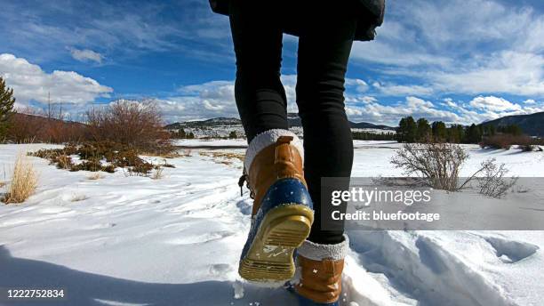 walking on snow with winter boots - sneeuwschoen stockfoto's en -beelden