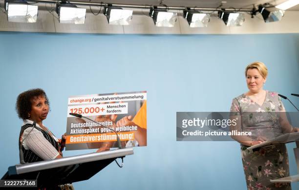 Faduma Korn , 1st chairperson of "NALA e.V. Bildung statt Bescheiden" , shows a poster of a collection of signatures against genital mutilation at...