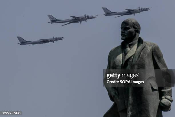 Russian Air Force Tupolev Tu-95MS bombers fly in formation over the Vladimir Lenin monument during the Victory Day military parade marking the 75th...