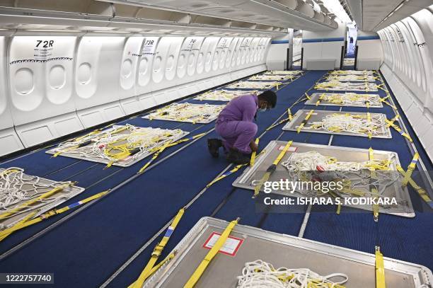 Sri Lankan Airlines worker gives final touches to an Airbus A330 passenger aircraft, converted as a cargo carrier at Bandaranaike International...