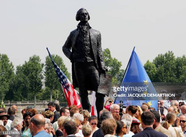 Guests gather around the statue of the third United States president, Thomas Jefferson after its unveiling by Paris Mayor Bertrand Delanoe and...