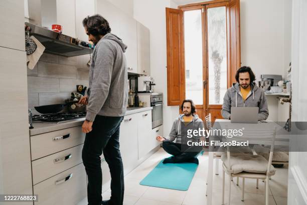 multi-tasking man doing many activities when he's in quarantine - multiple images of the same person stock pictures, royalty-free photos & images