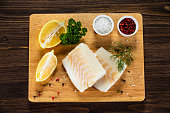 Fresh raw cod fillet on cutting board