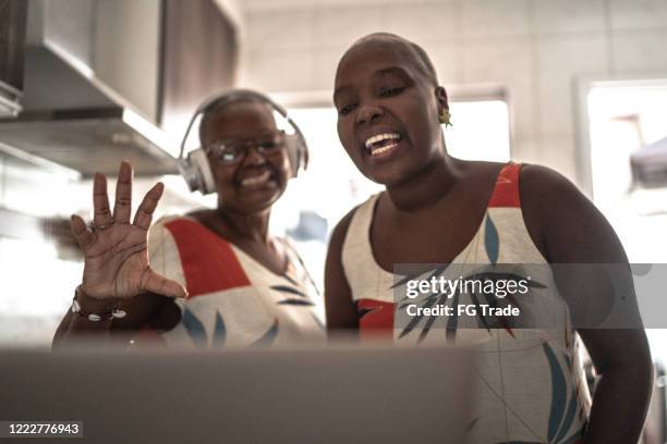 mother and daughter doing a video call / vlogging on digital tablet at home - misses vlog stock pictures, royalty-free photos & images