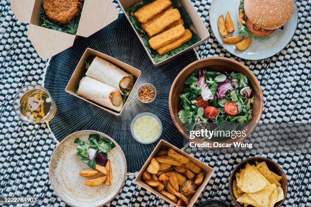 sharing takeaway food at home - convenience food stockfoto's en -beelden