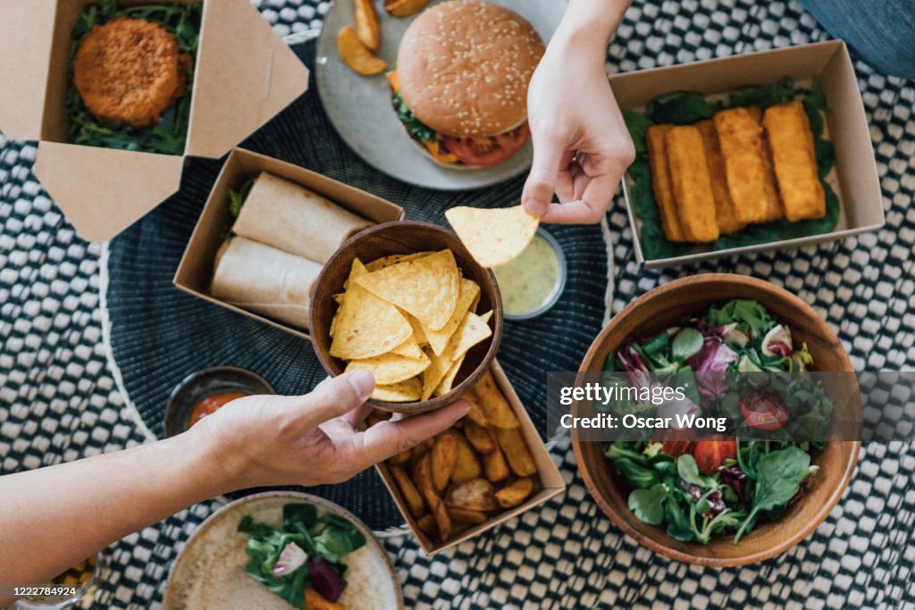 Couple Sharing Takeaway Food At Home
