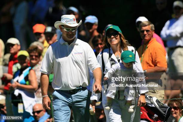Masters participant Rory Sabbatini of South Africa, left, walks the Par 3 Contest with wife Amy and their baby Bodhi at the 2011 Masters Tournament...