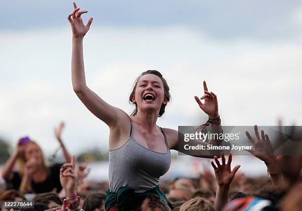 Music fan soaks up the atmosphere as Two Door Cinema Club perform live on the Main Stage during day two of Reading Festival 2011 on August 27, 2011...